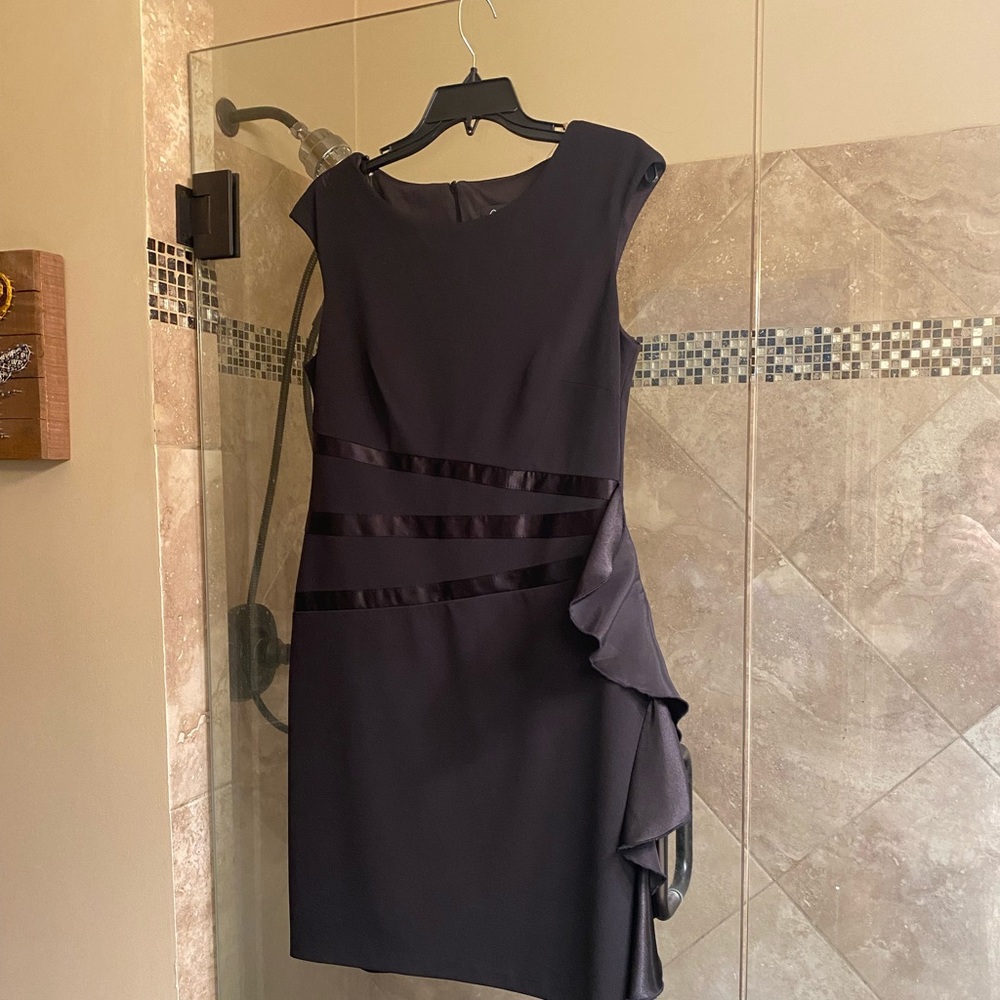Cute black dress with ruffle on side. Worn once